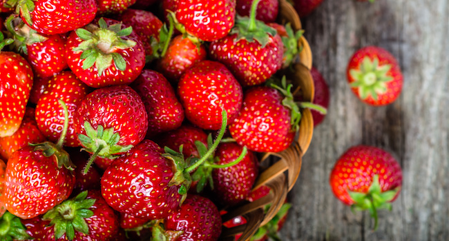 Fresh strawberries in the basket, fruits on farmer market table